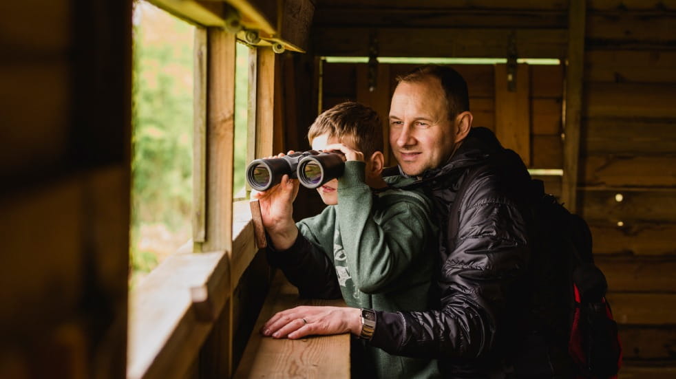 Man and boy birdwatching